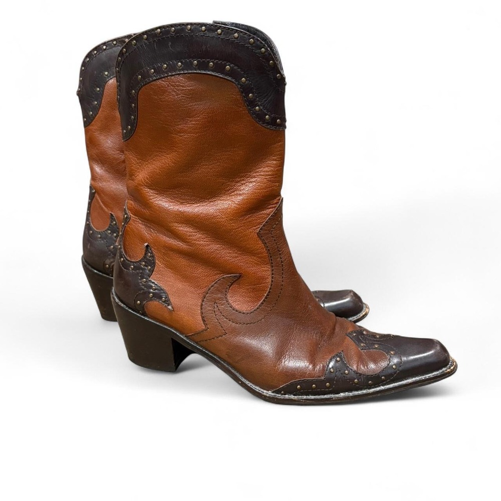 Stuar Weitzman Brown leather cowboy boots with studded details.